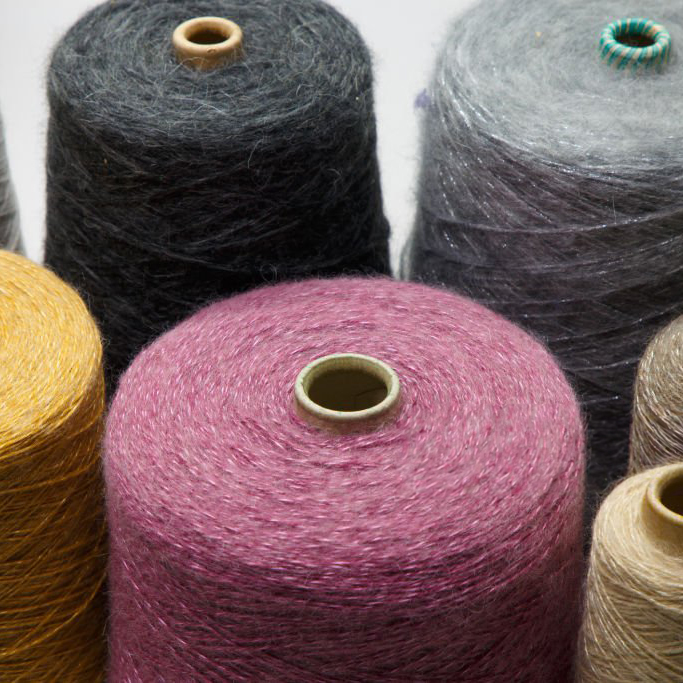 Colorful yarn on spool at the knitting factory. Yarn on tube, cotton, wool, linen thread.