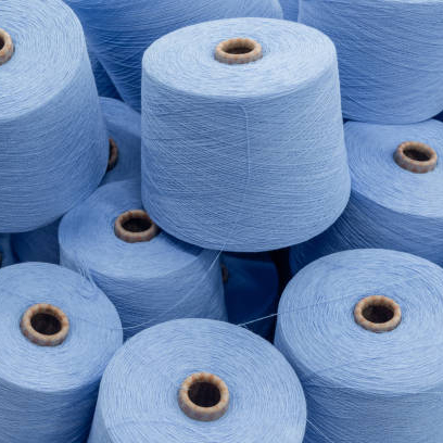 a large pile of spools of blue thread. close up